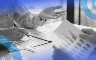 People looking at financial documents. Startups should consider hiring a CFO in the growth stage.