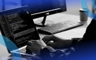 Person coding on macbook