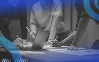 Three designers sketch while standing around a laptop