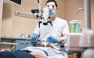 A dentist is pictured treating a patient.