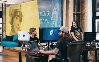 Members of the Hypergiant team work on computers.