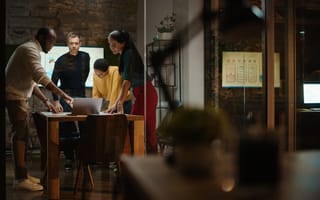 creative team collaborating in a glass conference room in a loft