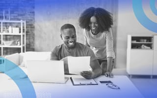 A happy couple working. Clearly defined roles and responsibilities can help couples successfully be in business together.