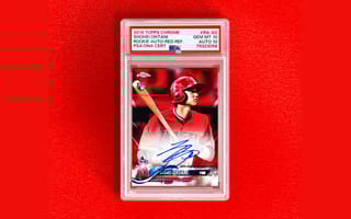 Photo of collectable baseball card featuring Shohei Ohtani, autographed, on a red background.
