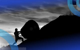 A man pushing a boulder up a hill.