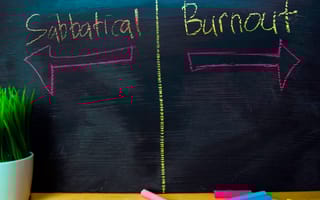 A blackboard features two arrows, one pointing toward “sabbatical” and the other pointing toward “burnout.”