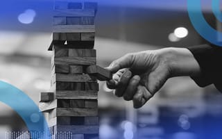 A hand playing the game jenga.