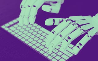 Robotic hands are shown typing on a computer keyboard.