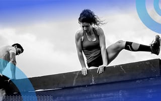 A person scaling a wall. Breathing and pausing are two tools to get you through tough situations.
