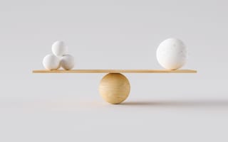 A scale with three stones on one side and one large stone on the other