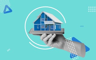 A hand holding a smartphone with a home on top of it.
