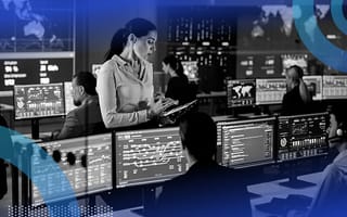 A woman leading a team of data scientists as they work on their desktops.