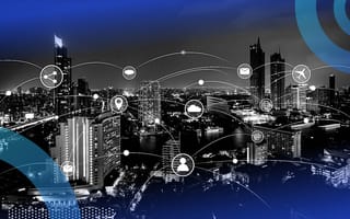 3 IoT Latency Issues and How to Fix Them A cityscape with different devices shown connected throughout the city.