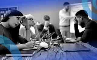 A group of people looking bored in a meeting.