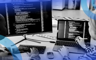 Implementing Enums in Golang Two developers working on code on a laptop