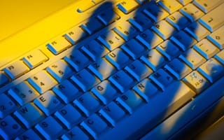 shadow of a hand over a keyboard