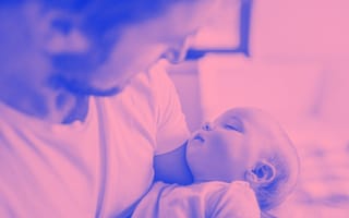 A photo of a father holding a newborn baby.