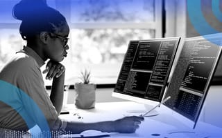 Software engineer reviewing code on computer screen