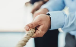 tug of war with a rope between office workers