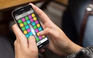 A person plays a game on a smartphone.
