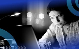 A person looking at a computer with suspicion.