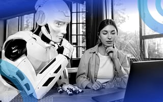 A robot and a person looking at a computer.
