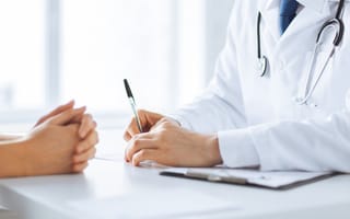 A doctor converses with a patient.