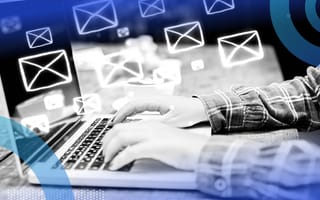 Writer typing emails on a laptop with a flurry of email icons