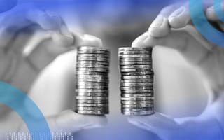 A person holding two equal stacks of coins.