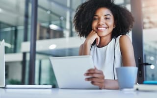 Cropped shot of a smiling young businesswoman working in her office.