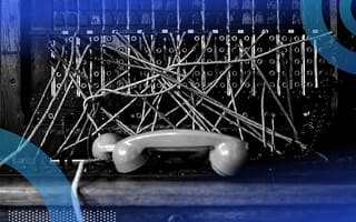 Phone switchboard tangle of wires with a phone on table