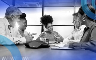 A group of business people sitting around a table in a heated discussion.
