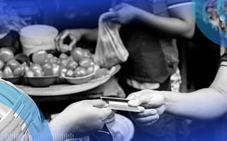 Two people exchanging a debit/credit card to purchase/sell fresh local tomatoes.