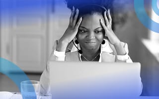 A woman wearing a headset appears frustrated while looking at a computer