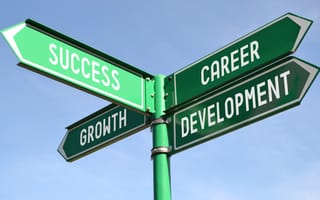 a signpost points toward “success,” “growth” and “career development”