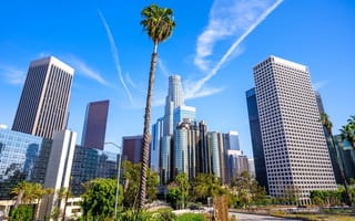 Several tall buildings stand against the Los Angeles skyline.