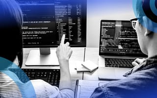 Two developers reviewing python code on computer