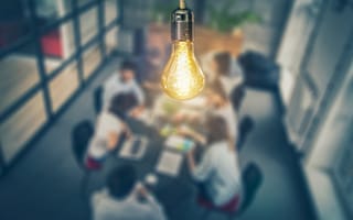 A digital illustration of a human silhouette in profile with an illuminated brain set against a backdrop of network connections.