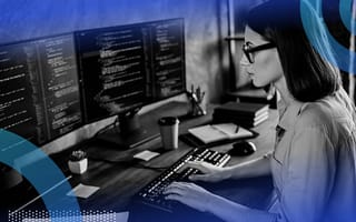 Developer writing JavaScript with two monitors