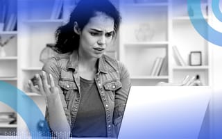 An upset person looking at a computer screen.