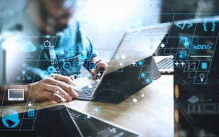 A person using a laptop to write code.