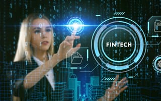 Person with long blonde hair interacts with a hologram that sys "Fintech."