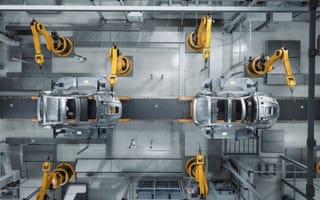 Image of a car production line in a factory.