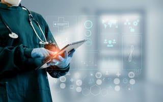 A doctor uses a tablet.