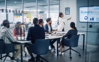 10 E-Commerce Companies in Bengaluru Executives in a meeting looking at a sales chart.