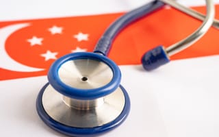 Stethoscope sitting on top of a Singapore flag.