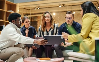 Group of young tech professionals working together in a casual environment.