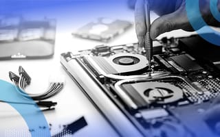 A close-up on the hand of someone repairing a dismantled laptop.
