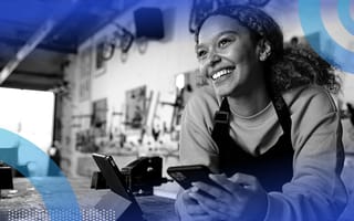 An entrepreneur looking happy in her workshop.