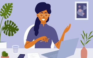 Woman taking part in virtual interview in home office setting